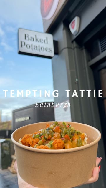 A short-form video review of Tempting Tattie in Edinburgh, featuring the preparation and tasting of two loaded baked potato dishes. The video uses a mix of handheld and close-up shots to highlight the food's appeal.