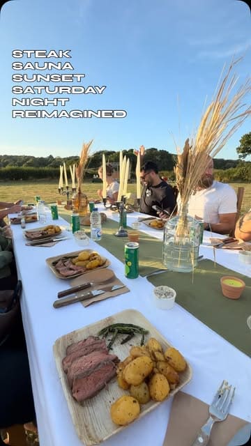 A montage video showcasing a unique outdoor event featuring a sauna, cold plunge, yoga, and a large steak feast in a field setting.