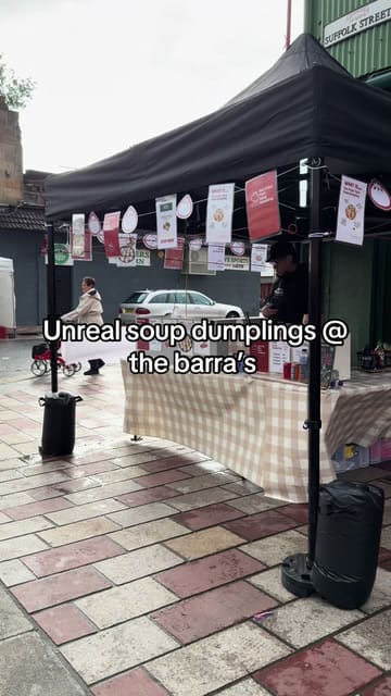 A short video showcasing a street food stall called Aunt Dordor at the Barras Market in Glasgow, focusing on their pan-fried soup dumplings. The video features shots of the stall, the cooking process, and the finished product, along with instructions on how to eat the dumplings.