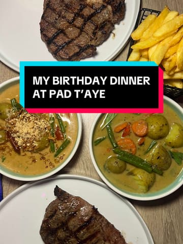 A personal vlog-style review of a Thai restaurant in Hamilton, Scotland, focusing on a birthday dinner experience. The creator highlights the 'Steak Wednesday' deal, showcasing the ribeye steak, Thai curry, calamari, and duck fat chips, while also giving a tour of the venue's vibrant, neon-lit interior.
