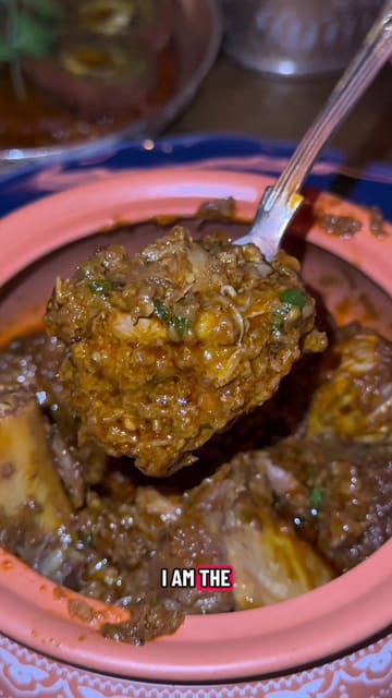 A review of Ambassador's Clubhouse in London, highlighting their Michelin-starred Punjabi cuisine. The creator showcases various dishes including jumbo wild prawns, butter chicken chops, and lamb curries, while also commenting on the upscale interior and cocktail offerings.