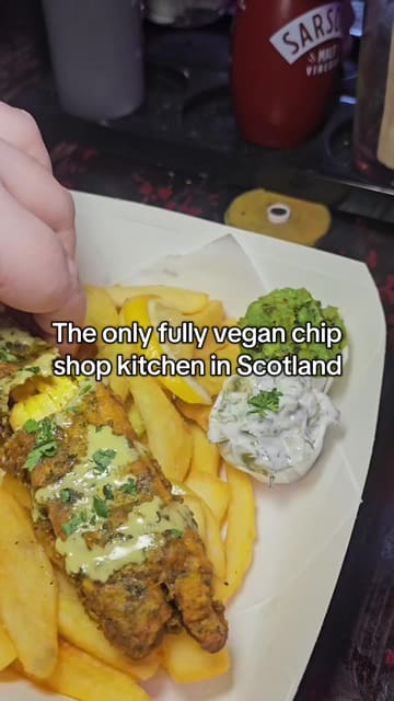A review of a vegan chip shop kitchen called The Happy Fish located inside The Dog House bar in Edinburgh, showcasing their vegan fish and chips, cocktails, and the venue's unique atmosphere.