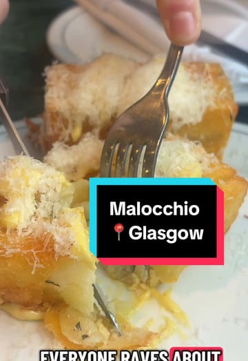 A creator visits Malocchio, an Italian restaurant, for lunch. The video features a tour of the interior, a look at the menu, and close-ups of several dishes including crispy potatoes, burrata with pear, vodka sauce pasta, camembert pizza, and nduja sausage pasta.