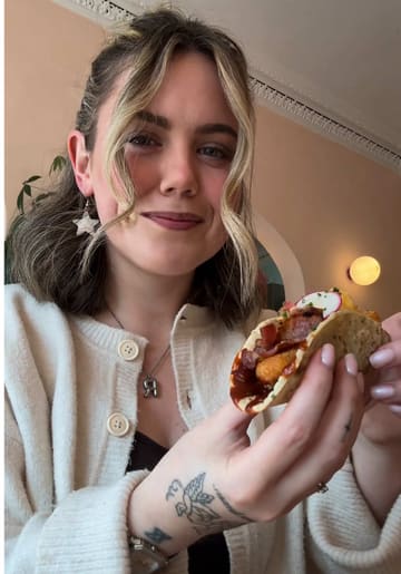 A creator reviews a brunch menu at Bodega in Edinburgh, highlighting their breakfast tacos and the fact that the entire menu is gluten-free. The video features shots of the food, the menu, and the venue interior.