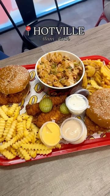 A promotional video for the opening of Hotville in Alum Rock, featuring close-up shots of burgers, loaded fries, and chicken tenders being dipped in sauce. The video highlights the food and the opening offer.