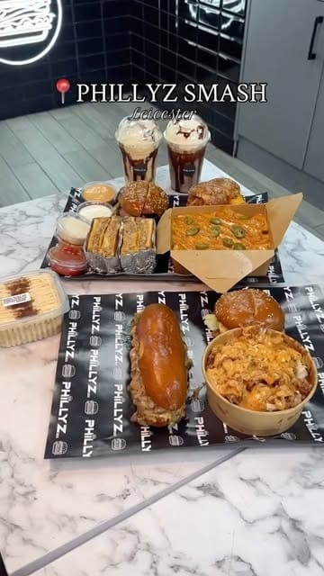 A promotional video for Phillyz Smash in Leicester, showcasing a variety of their indulgent comfort food offerings including Philly cheesesteaks, smash burgers, loaded fries, and mac and cheese.