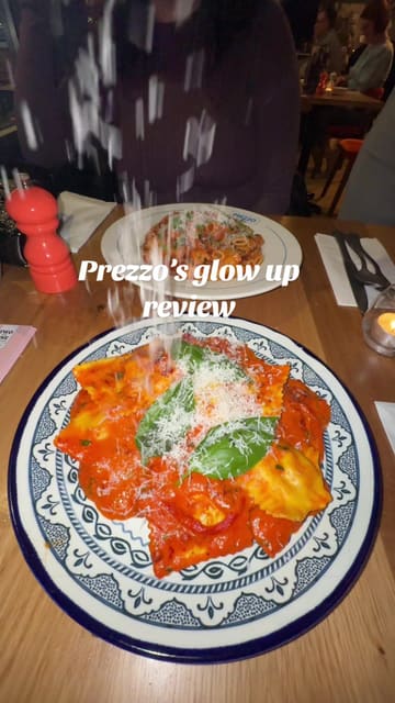 The video is a review of a Prezzo restaurant in Chelmsford. The creator provides a voiceover review while showing the interior, menu, and various dishes including arancini, garlic bread, calamari, and pasta. The video highlights the open kitchen feature and the casual dining experience.
