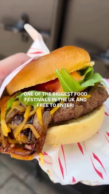 A creator visits the Bolton Food Festival, sampling a wide variety of street food items including burgers, corn dogs, pulled pork wraps, mac and cheese, ice cream, churros, and noodle bowls. The video captures the lively atmosphere of the festival, featuring music and crowd shots alongside the food reviews.