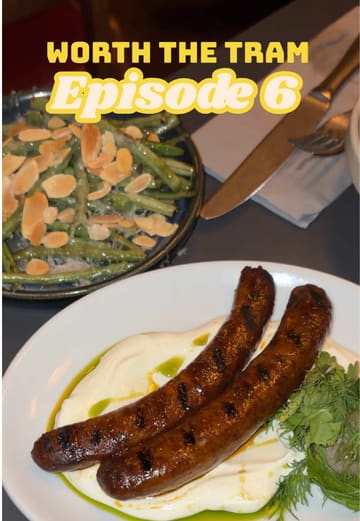 A vlog-style review of Volta in Didsbury, Manchester, part of a 'Worth the Tram' series. The creator showcases various small plates including padron peppers, miso butter hispi cabbage, and steak, while providing commentary on the food and the restaurant's atmosphere.