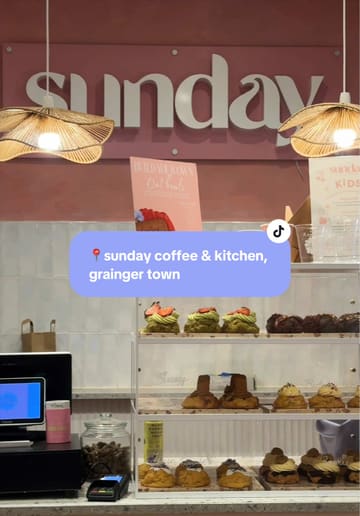 A short, aesthetic montage showcasing the interior and menu items of a pink-themed cafe in Newcastle, featuring matcha drinks and various baked goods.