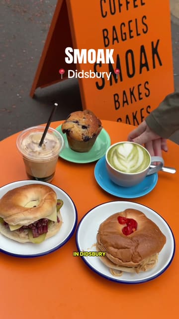 A high-energy, engaging vlog review of a bagel shop in Didsbury, Manchester, showcasing their signature 30-day cured salt beef Reuben bagel, chicken banh mi bagel, and house-baked blueberry muffins.