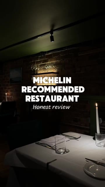 A couple reviews a restaurant in Glasgow, showcasing the open kitchen, the interior, and several courses of their meal, including snacks, mains, and dessert.