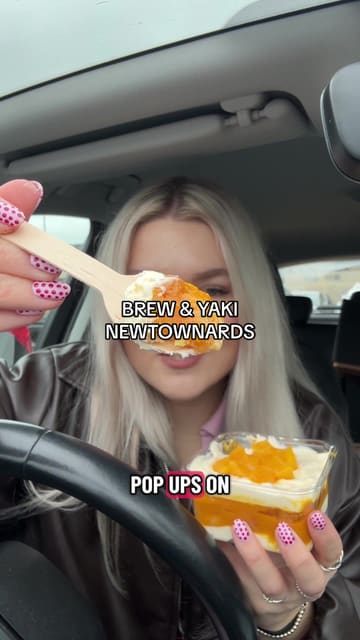 A creator visits 'Brew & Yaki' in Newtownards to review their unique mango tiramisu, iced matcha, ube mochi cookie, and various mochi flavors. The video features the creator's reactions, shots of the venue's interior and exterior, and close-ups of the food.