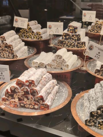 A review of Hafiz Mustafa 1864 in Knightsbridge, showcasing the ornate interior, Turkish sweets, and specific desserts like kunafa and tres leches.