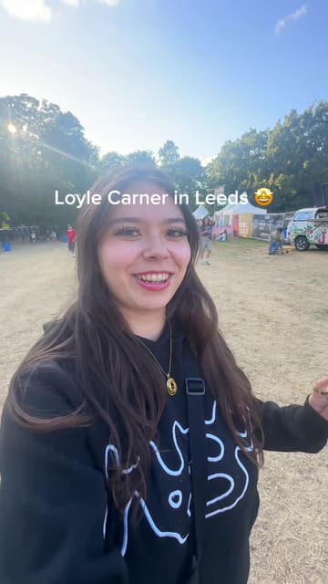 A vlog-style video capturing a live music performance by Loyle Carner at Kirkstall Abbey in Leeds. The video features clips of the artist on stage, the crowd, the venue, and incidental shots of food and drink.