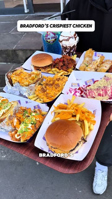 A high-energy review of NYK Fried Chicken, featuring a wide spread of their menu items including burgers, loaded fries, fried chicken, wings, cheesecake, and milkshakes. The creator provides a walkthrough of the venue and shares his thoughts on the food quality.