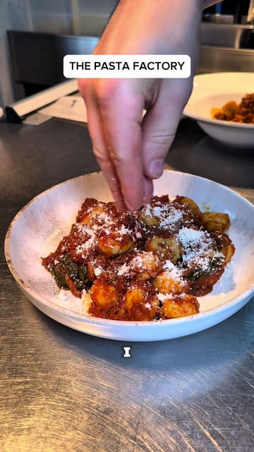 A review of The Pasta Factory in Manchester, featuring a look at the kitchen's fresh pasta preparation, the restaurant's interior, and the creator's tasting experience of various dishes.