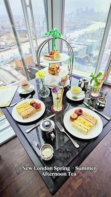 A high-quality, visually appealing reel showcasing the Spring-Summer afternoon tea service at TĪNG in the Shangri-La The Shard. The video features close-ups of the tiered food display, including sandwiches, scones, and pastries, alongside cocktails and tea, all set against the backdrop of panoramic London skyline views.