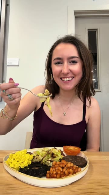 The creator visits Loudons in Edinburgh to review their vegan brunch options. The video features a mix of personal commentary, shots of the cafe interior, and a behind-the-scenes look at the kitchen where they prepare their bakery items, specifically a dark chocolate cashew cheesecake.