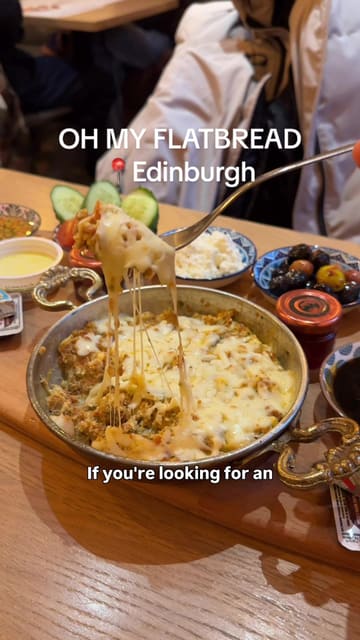 A video review of 'Oh My Flatbread' in Edinburgh, highlighting their 'Break-feast' Turkish breakfast platter which includes a variety of sides and a main dish.