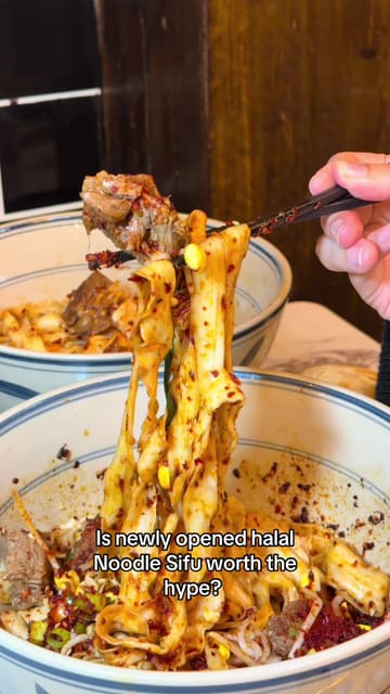 A short video showcasing the newly opened Noodle Sifu restaurant, highlighting the queue, the interior, the kitchen staff preparing hand-pulled noodles, and a variety of dishes served.