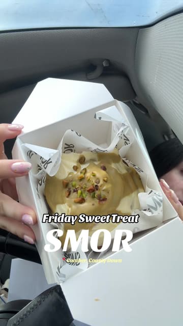 A creator visits a small bakery called SMOR in Comber to pick up a pistachio cinnamon roll and an iced coffee, sharing her experience as a Friday sweet treat.