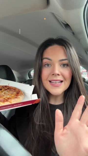 A creator reviews a 'No Brainer' deal from Apache Pizza, showcasing a medium pizza and a side dish while eating in a car.