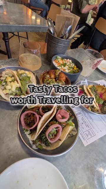 A montage of various tacos, sides, and cocktails at a Mexican restaurant, showcasing the menu items and the interior.