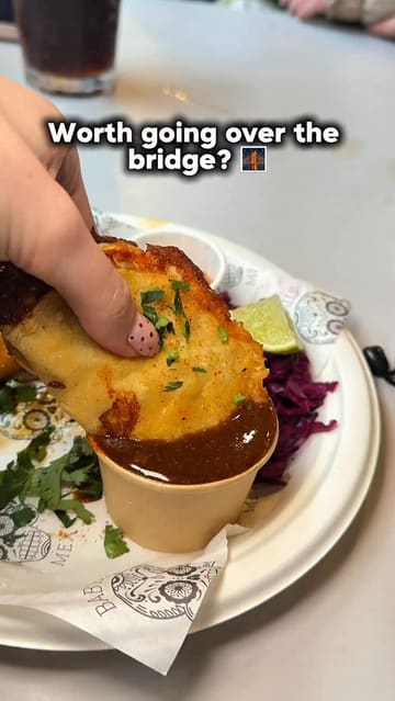 A fast-paced review of Newport Market, highlighting various food traders and dishes including tacos, arancini, burgers, and brownies. The video uses a handheld vlog style to showcase the variety and appeal of the food hall.