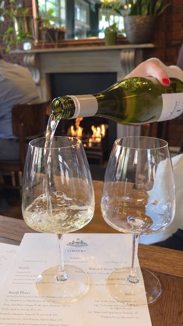 The video is a short, engaging review of a neighbourhood wine bar called Corners in Surbiton. It features shots of the interior, including a fireplace, and highlights various small plates and drinks, such as hake cassoulet, mac and cheese, and pistachio creme brulee.