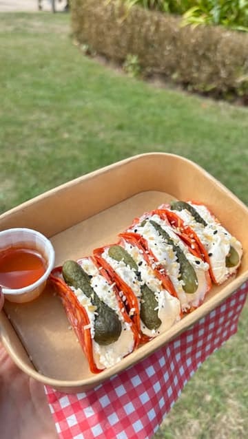 A vlog-style video documenting a visit to a pop-up market at the Palm House in Sefton Park, featuring various food vendors including charcuterie tacos, lemonade, and ice cream.