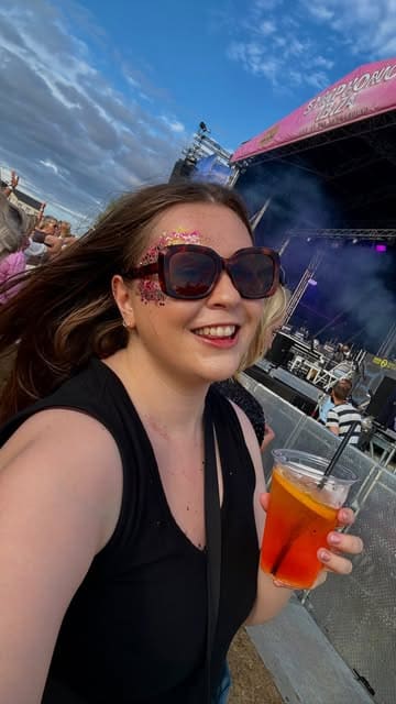 A recap video of the Symphonic Ibiza event in Harrogate, featuring clips of the DJ, live performers, the crowd, and attendees enjoying drinks in an outdoor festival setting.