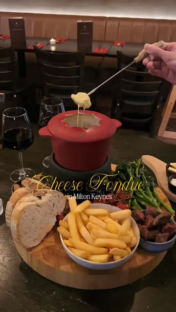 A short, engaging reel showcasing a cheese fondue dining experience at The Residence in Milton Keynes. The video features close-up shots of the food, the restaurant's interior, and live music, creating an inviting atmosphere for a night out.