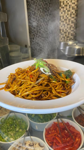 A montage video showcasing the food offerings and live cooking stations at Quayside Buffet. The video features clips of chefs preparing stir-fry and pasta, followed by shots of the extensive buffet spread including pizza, Indian dishes, fried chicken, and a dessert station.