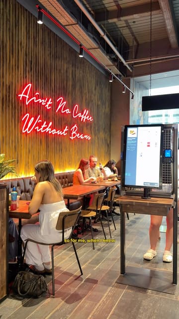 A creator visits a newly opened Black Sheep Coffee location in Derbion, showcasing the interior, the menu, and the suitability of the space for working with a laptop.