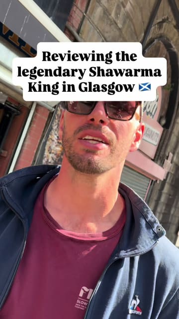 A candid, handheld review of a shawarma wrap from Shawarma King in Glasgow, featuring two presenters sharing their thoughts on the flavour, value, and overall quality of the food.