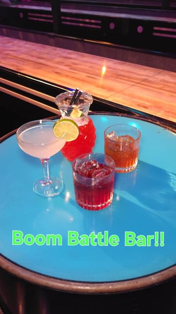 A couple visits Boom Battle Bar to try their new activity bundle, featuring shuffleboard, cocktails, and a variety of street food plates.