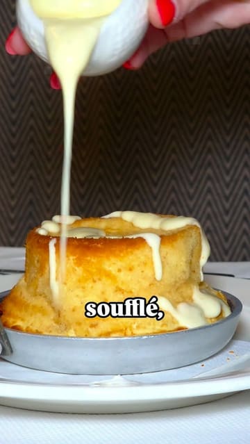 A polished, high-quality food reel featuring a variety of French-inspired dishes and drinks at Brasserie Blanc. The video uses slow-motion close-ups and smooth transitions to highlight the texture and presentation of items like cheese soufflé, steak tartare, duck confit, and desserts, accompanied by text overlays identifying each dish.