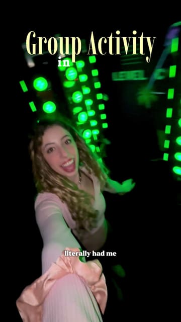 A fast-paced, energetic video showcasing an interactive group activity venue in London called Boom Lab. The creator takes the viewer through various challenge rooms, including laser mazes and paint-based games, highlighting the fun, competitive atmosphere suitable for groups of friends.