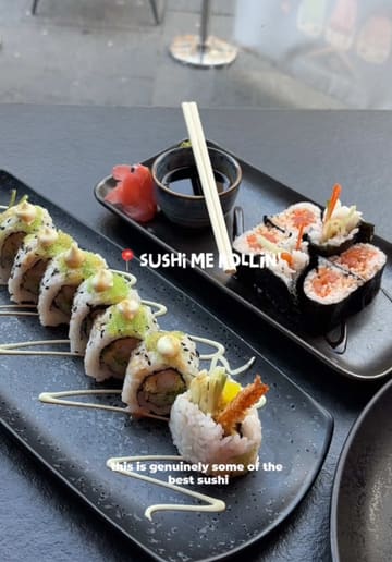 A vlog-style review of a sushi restaurant in Newcastle, showcasing the interior, menu, and various sushi dishes.