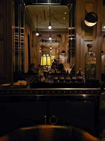 A short, cinematic video showcasing the signature martini trolley service at the Connaught Bar in London. The footage focuses on the bartender preparing the drink with precision, highlighting the luxury setting and the bespoke nature of the cocktail experience.