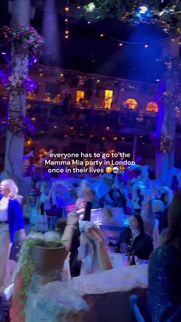 A short, energetic video capturing an immersive Mamma Mia-themed party in London. The footage shows guests dancing, singing along to ABBA, and interacting with performers in a Greek-taverna-style venue, highlighting the lively and communal nature of the event.