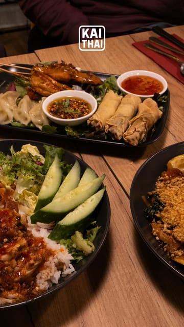 A montage of various Thai dishes and drinks at Kai Thai, featuring close-ups of food being served and eaten, along with a brief shot of the restaurant's interior decor.