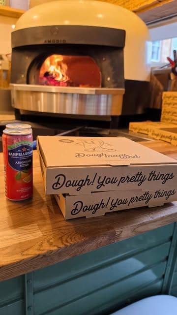 A short, engaging review of Doughman's Land, a pizza truck located near Kelvingrove Park in Glasgow. The video features the preparation process, the wood-fired oven, and the creator tasting various pizzas in the park.