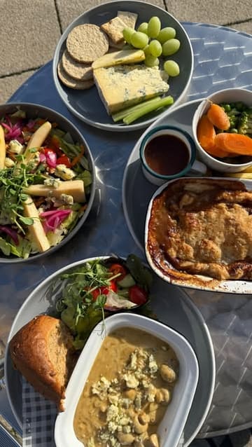A creator visits The Bees Country Kitchen in Chorley to review their limited-time Stilton Week menu, featuring a beef pie, mushroom bake, salad, and cheese plate.
