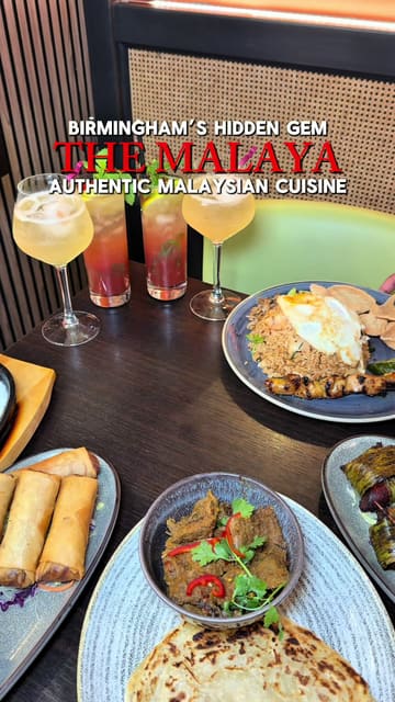 A promotional video showcasing the interior and various dishes at The Malaya Classic in Birmingham, including beef rendang, roti canai, satay bao buns, and mocktails.
