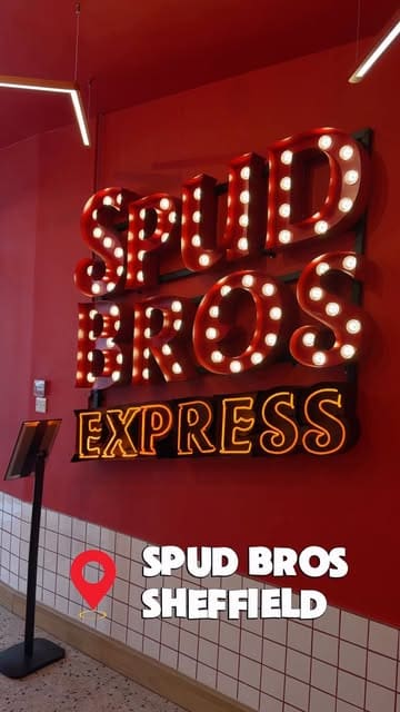 A short video showcasing the preparation and final presentation of loaded jacket potatoes at Spud Bros in Sheffield, featuring staff assembling the dishes and a customer enjoying the meal.
