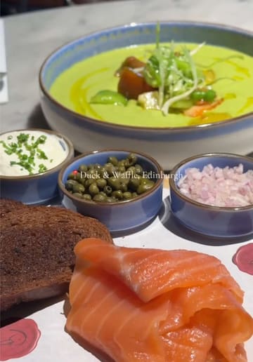 A short, polished montage showcasing a selection of dishes from the set menu at Duck & Waffle in Edinburgh, including a crab cake, risotto, smoked salmon, cheesecake, and a waffle dessert.