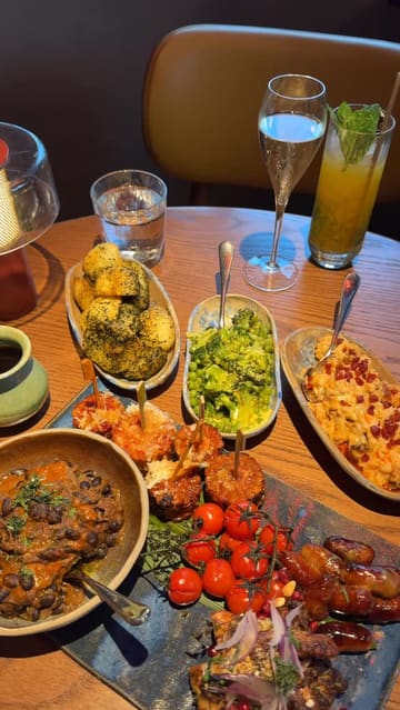 A creator visits Chotto Matte in Manchester to try their Peruvian-inspired Sunday roast, showcasing the venue's interior, a cocktail, and a large sharing platter with various sides.