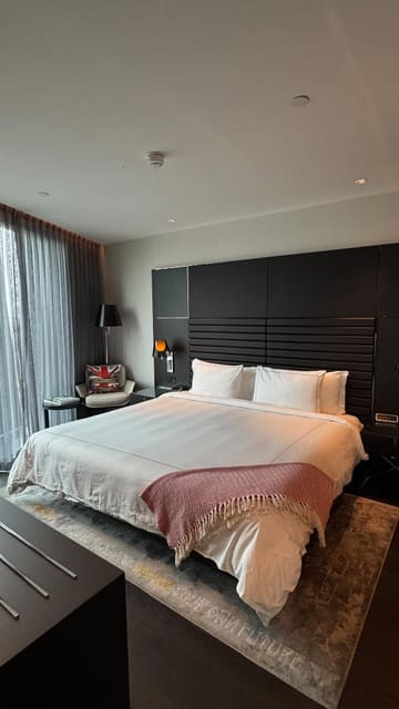 A short, aesthetic video tour of a one-bedroom apartment at the art'otel London Hoxton, highlighting the room's decor, cocktail station, and vinyl record player.